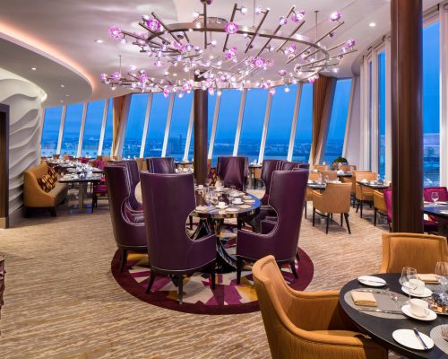 Coastal Kitchen SY, Symphony of the Seas, Coastal Kitchen restaurant - Deck 17 Midship Portside, table seating, shoreside view window at night, evening, dusk, decor, decorative lighting